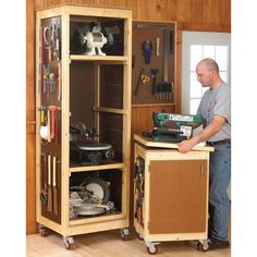 a man standing in front of a cabinet filled with tools