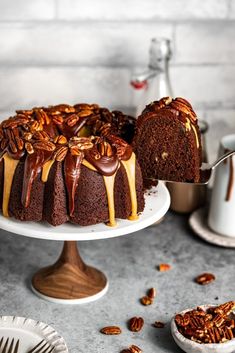 a bundt cake with pecans and caramel drizzle on top