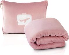 a pink blanket and pillow sitting next to each other