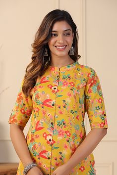 This mustard Floral Print A-line Kurta Set exhibits button down placket with coconut buttons details, sleeves has cuff and tab button along with Mandarin Collar & 3/4th Sleeves. Tailored from Cotton blend . Product Length: 45 Inches. Description  Size - Measuring Unit  : Regular Size                                 :  ( S, M, L, XL, XXL )  Ideal For                         :    Women Sales Package               :     1 Kurta::1 Palazzo Sleeve Length               :      3/4 Sleeve Pattern Mustard Color Straight Kurta Set, Mustard Straight Kurta Sets, Spring Yellow Tops With Printed Motifs, Yellow Floral Print Sets For Navratri, Yellow Printed Kurta For Spring, Yellow Floral Print Kurta For Festive Occasions, Festive Yellow Kurta With Floral Print, Yellow Floral Print Kurta For Diwali, Traditional Printed Yellow Tops