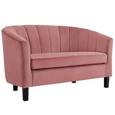 a pink couch sitting on top of a white floor