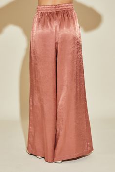 Upgrade your wardrobe with our sleek Molita Wide Leg Pants. These rose-colored pants offer a stretch waist for comfortable wear and a wide leg design for a stylish look. Perfect for any occasion, these pants are a must-have for your collection. Waistline: High Wasted Length: Full Length Features: Back Elastic Band Material: 100% Poly Stretch: Stretchy Sheer: No Care instructions: Machine wash cold. Tumble dry low. Model is 5'9'' and is wearing a size Small (Model Specs- 32/24/34) Chic Romper, Waistband Pants, Elastic Waistband Pants, Colored Pants, Bralette Tops, Top Graphic Tees, Leg Design, Trendy Clothes For Women, Office Outfits