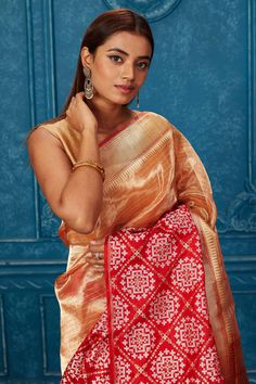 Look your best at weddings and festive occasions in this beautiful golden Banarasi saree with red zari border. It comes with a matching blouse piece. Disclaimer: The shown stitched blouse on the model is for display purpose only. The saree comes with a matching blouse piece and finished with fall and piko. Red Traditional Wear With Zari Work In Tissue Silk, Traditional Gold Paithani Silk Pre-draped Saree, Gold Meenakari Pre-draped Saree, Traditional Gold Pre-draped Tissue Silk Saree, Red Zari Work Saree In Tissue Silk, Red Tissue Silk Saree With Zari Work, Traditional Gold Tussar Silk Blouse Piece, Gold Paithani Silk Pre-draped Saree, Gold Meenakari Tussar Silk Blouse Piece