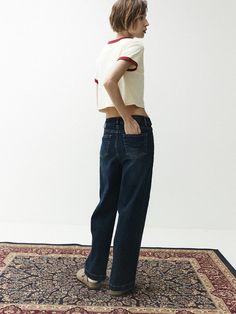 The displayed trousers are a classic five-pocket style, a common design in casual bottoms. They are constructed with a straight-leg fit, which is versatile and flattering for various body types. The trousers have a sturdy waistband with belt loops and a front closure, indicating a traditional and functional design.- The stitching details are prominent, suggesting strong construction and durability.- There's a lack of fading or distressing, which often indicates a more formal or clean look in denim garments.- These trousers appear to be a staple piece, capable of being dressed up or down for different occasions. Denim Garments, Casual Bottoms, Stitching Details, Staple Pieces, Functional Design, Denim Pants, Body Types, Straight Leg, Stitching