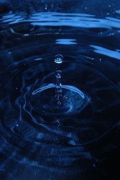 a water drop that is falling into the air