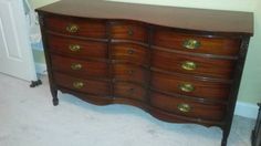 an old dresser with brass pulls and knobs on the bottom drawer is shown in this image