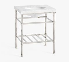 a white sink sitting on top of a metal stand