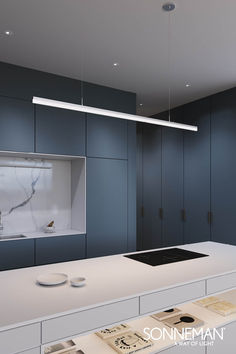 an empty kitchen with blue cabinets and white counter tops is featured in this rendering image