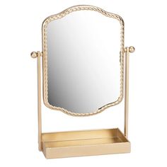 a gold mirror on a stand with a drawer underneath it and an empty tray under the mirror