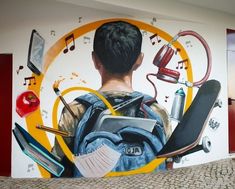 a mural painted on the side of a building depicting a man with a backpack and school supplies