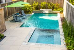 a small pool with chairs and an umbrella