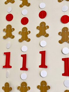 gingerbread themed first birthday party decoration with red and white paper circles, one number