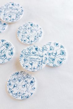 four blue and white plates sitting on top of a table