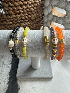 Embrace the spooky spirit with this handcrafted bracelet stack, perfect for Halloween or year-round wear!  This versatile and stylish accessory combines festive and chic elements: *Gold-filled beads: Add a touch of elegance and durability. *Clay beads: Lightweight and colorful, adding a fun and festive vibe. *Gemstones: Natural stones that bring energy and beauty to your look. *Skull accents: A spooky yet trendy touch for Halloween and beyond.  * Sized 7"   * Two stack styles available in drop down  Whether you're celebrating the spooky season or love a bold, edgy style all year long, this bracelet stack is the perfect addition to your collection! Care Instructions for Stretch Cord Jewelry: To keep your stretch cord bracelets in great condition: *Avoid overstretching when putting on or rem Bohemian Bracelets For Halloween Gift, Bohemian Handmade Bracelets For Halloween, Halloween Stretch Bracelets, Handmade Bohemian Bracelets For Halloween, Bohemian Halloween Gift Bracelets, Adjustable Gold Bracelets For Halloween, Adjustable Beaded Stretch Bracelet For Halloween, Adjustable Multicolor Beaded Bracelets For Halloween, Novelty Multicolor Beaded Bracelets For Halloween