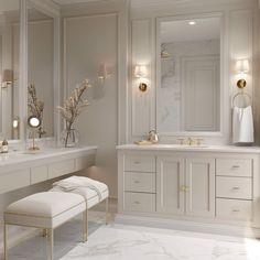 a white bathroom with gold accents and marble counter tops, along with a bench for two