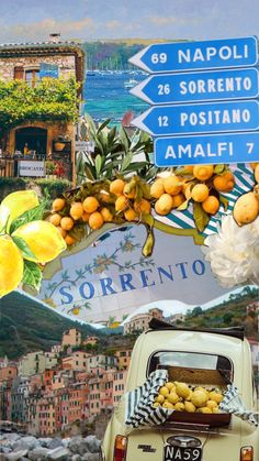 an old car parked in front of a street sign with flowers and fruit hanging from it's roof