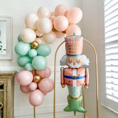 a balloon arch with a nutcracker and balloons