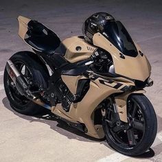 a tan motorcycle parked on the side of a road