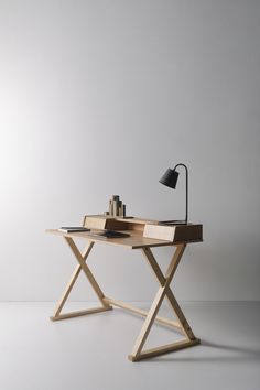 a wooden desk with a lamp on top