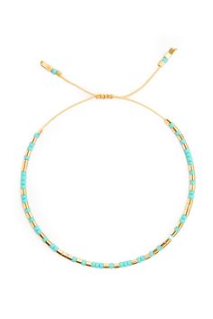 the turquoise and gold beaded bracelet is shown on a white background with an adjustable cord