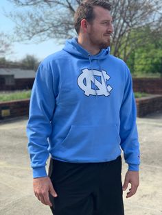 UNC Game Day Hoodie by Champion – Shrunken Head Fan Apparel Long Sleeve Sweatshirt With Adjustable Hood, Blue Hooded Hoodie For Sports Events, Collegiate Long Sleeve Fleece Hoodie, Fan Apparel Hoodie With Drawstring, Collegiate Sweatshirt With Adjustable Hood And Long Sleeves, Blue Hoodie With Drawstring Hood For Sports Events, Blue Fan Apparel Sweatshirt For Fall, Fan Gear Long Sleeve Hoodie With Adjustable Hood, Team-colored Varsity Long Sleeve Hoodie