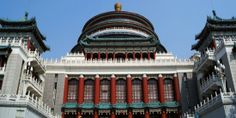 an ornate building with red and white columns