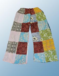 Introducing our Wevez Patchwork Pants, perfect for any casual occasion. These pants come in a beautiful pink and blue pattern and are made of high-quality cotton fabric with a drawstring closure and elastic waist for a relaxed fit. The wide-leg style and patchwork accents give these pants a unique hippie boho vibe, making them a great addition to any wardrobe. These one-size-fits-all pants are suitable for women of all sizes and are perfect for yoga, urban outings, or just lounging at home. The palazzo style adds to the comfortability of the pants while the cotton material provides breathability and durability. Get your hands on these stylish pants from the trusted brand Wevez today! Pink Cotton Patchwork Pants, Purple Cotton Patchwork Bottoms, Bohemian Non-stretch Multicolor Pants, Non-stretch Denim Patchwork Pants, Non-stretch Patchwork Denim Pants, Patchwork Pants, Palazzo Style, Pants Boho, Boho Yoga