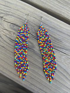 These fringe earrings are so colorful and will go well with any outfit! The colors of the beads are chosen in no particular order therefore each earring will not be the same. The different colors used to make these earrings are turquoise, blue, green, red, orange, and yellow. Details: * Handmade * Toho Seed Beads * Nylon Thread * Nickel Free Ear Hook * Length - 4.01 in * Width - 0.78 in Fringe Earring, Boho Earring, Beaded Earring, Toho Beads, Earring Handmade, Beaded Fringe, Pretty Earrings, Ear Hook, Heart Beads