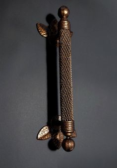 an ornate metal object is hanging on the wall