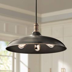 a light fixture hanging from the ceiling in a kitchen