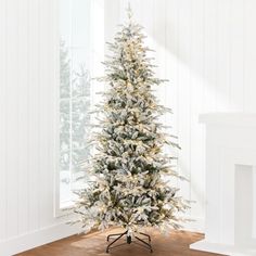 a white christmas tree with snow on it