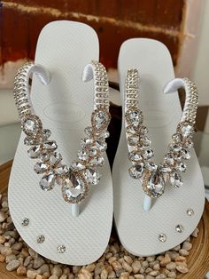 All Design by Desire products are handcrafted and customized with the finest Brazilian embellishments. We use the original Havaianas®️ flip flops: thong style / made in Brazil / 100% rubber / non slip / tread durable and flexible. Elegant Gold Toe Post Flip Flops, Wedding Toe Post Sandals With Rhinestones, Elegant Gold Flip Flops For The Beach, Elegant Gold Flip Flops For Beach, White Sandals With Rhinestones And Adjustable Fit, Elegant Gold Party Flip Flops, Elegant Rhinestone Flip Flops For Summer, Elegant Crystal Embellished Sandals For Vacation, Elegant Embellished Flip Flops For Vacation