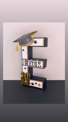 the letter e is decorated with a graduation cap