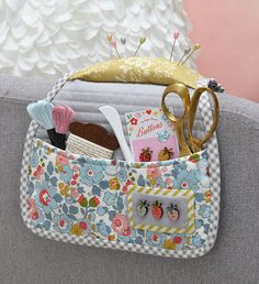 a close up of a purse with scissors and other items in it