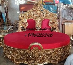 an ornate gold and red bed frame in a room filled with other antique furniture items