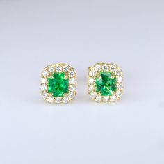 RRV: $11,970 An exquisite pair of Emerald and Diamond Stud Earrings feature a pair of natural Colombian emeralds of an incredible vivid green colour and breathtaking clarity. The emeralds are cut to the desirably emerald shape and are adorned by a halo of round brilliant cut diamonds that follow the shape to create the most stunning stud earrings.  These Emerald and Diamond Stud Earrings are the perfect cocktail earrings but being sophisticated enough they are also suitable for the everyday dazz Green Emerald Cut Diamond Earrings For Anniversary, Emerald Cut Green Diamond Earrings For Anniversary, Gia Certified Green Diamond Earrings Gift, Gia Certified Green Diamond Earrings For Anniversary, Gia Certified Green Earrings In Fine Jewelry Style, Green Diamond Earrings With Halo Design For Anniversary, Green Emerald Diamond Earrings For Anniversary, Green Diamond Earrings With Halo Design, Green Emerald Diamond Earrings With Prong Setting