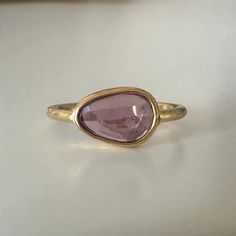 A stunning natural pink purple sapphire is set into a 22k yellow gold bezel with an 18k band. This stone is completely unheated and untreated which only about 10% of sapphires on the market are! The stone is pinker than what appears in the photos- the truest color is shown on my hand. This would make an excellent alternative bridal option as sapphires are a 9 on the Moh's hardness scale. Size: 6.5 (can be sized- please inquire) Finish: Brushed finish- can be high polish if noted  Sapphire: measures approximately 7x10mm Purple Gemstone Ring, Hardness Scale, Alternative Bridal, Purple Sapphire, Purple Rose, Purple Roses, Gemstone Ring, Rose Cut, Rings Statement