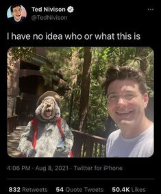 a man standing next to a stuffed animal on top of a cell phone with the caption i have no idea who or what this is