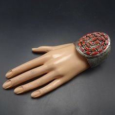 "VINTAGE NAVAJO BRACELET DESCRIPTION: This outstanding cuff features clustered cabs of old red Mediterranean coral. The gemstones are secure in smooth bezel, on a foundation of heavy gauge vintage sterling silver. This bracelet will be a cherished addition to your collection of fine vintage Native American jewelry. MEASUREMENTS: Interior of the cuff measures 5 7/8\" with an additional 1 1/4\" slightly adjustable gap. Total circumference: 7 1/8\" Measures 2 3/8\" straight across the widest part ( Vintage Handmade Red Bangle, Red Adjustable Vintage Cuff Bracelet, Vintage Red Adjustable Cuff Bracelet, Red Vintage Adjustable Cuff Bracelet, Red Metal Bohemian Bangle, Red Bohemian Metal Bangle, Bohemian Red Metal Bangle, Vintage Red Adjustable Bangle, Vintage Red Metal Bangle