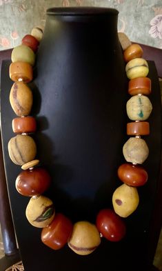 Museum quality beaded necklace!  These are highly sought after African Kronos beads that usually sell one at a time. And here are 11 in one place, resting between old African copal beads. The center bead alone is 35 mm x 35 mm.  There are 12 large old African copal beads Artisan Jewelry With Large Rondelle Beads, Hand-strung Amber Jewelry With Round Beads, Hand-strung Round Amber Bead Jewelry, Traditional Rondelle Jewelry With Large Beads, Artisan Amber Necklace Single Strand, Traditional Rondelle Beaded Necklaces With Large Beads, Artisan Amber Single Strand Necklace, Antique Amber Jewelry With Large Beads, Artisan Beaded Necklace With Large Round Beads