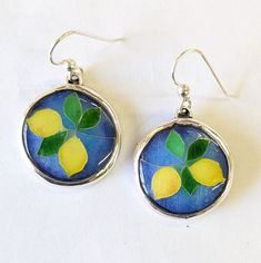 Just in time for Spring, these Lemon Cloisonne earrings were hand crafted in the USA using silver wire on fine silver and multiple layers of vitreous enamels, with each layer applied by hand and fired in a kiln. The finished cloisonne pieces are set in sterling silver with sterling silver ear wires. Unique Hand Painted Sterling Silver Jewelry, Hand Painted Silver Dangle Jewelry, Hand Painted Silver Round Jewelry, Hand Painted Sterling Silver Earrings For Gift, Hand Painted Sterling Silver Jewelry For Art Collection, Hand Painted Round Sterling Silver Jewelry, Hand Painted Sterling Silver Dangle Jewelry, Hand Painted Round Silver Jewelry, Hand Painted Silver Enamel Jewelry