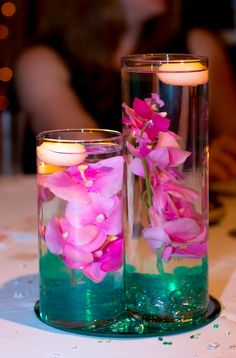 two vases filled with flowers on top of a table