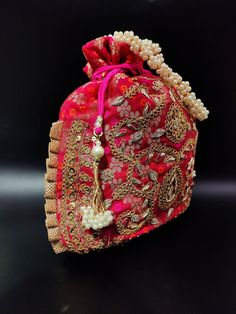 "fancy indian handmade woman embroider potli bag | magenta pink flower evening purse | ethnic ladies fabric purse with beaded handle Package Contents: 1 Size: 10\" x 8\" Designed with the heart, this beautiful Potli or batawa bag are eye catchy and made of premium material. Key Features: Embroidery art work. This potli is good match with both Indian and western outfits and are superb for wedding and festive parties. This would be best complement to your designer saree, lenhga or any other kind o Indian Wedding Giveaways, Party Face Masks, Fabric Purse, Potli Bag, Potli Bags, Fabric Purses, Evening Purse, Magenta Pink, Modern Embroidery