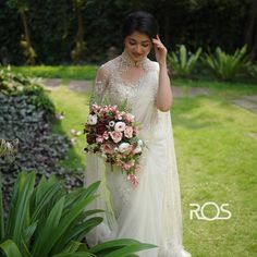 a woman in a white dress holding a bouquet