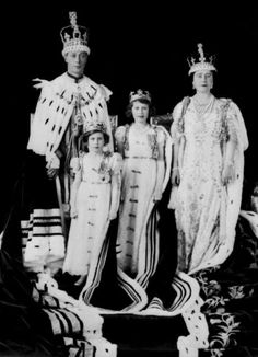 an old black and white photo of some people in costumes with crowns on their heads