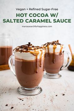 hot cocoa w / salted caramel sauce in glass mugs with text overlay reading vegan + refried sugar - free hot cocoa w / salted caramel sauce