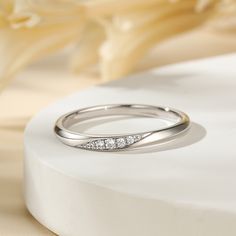 Simply and chic, this band is a clever accessory you will love. Featuring white stones, this band is an elegant symbol of your marital commitment. Buffed to a brilliant luster, this comfort-fit wedding band  will make your vows shine.Carat Weight: 0.086 ctStone Size: 1.1,1.3,1.5 mmStone Type: Jeulia® StoneNumber of Stones: 5 Stone Color: Diamond WhiteStone Shape: RoundWeight: 1.6 gWidth: 1.8 mmHeight: 1.8 mmThickness: 1.1 mmMaterial: 925 SilverPlating Color: Silver Minimalist Half Eternity Band For Formal Occasions, Modern Round Cut Wedding Jewelry, Minimalist Formal Half Eternity Band, Minimalist Diamond Eternity Band For Formal Occasions, Minimalist Half Eternity Diamond Ring For Formal Events, Minimalist Diamond Bands For Anniversary, Formal Minimalist Diamond Eternity Band, Minimalist Diamond Anniversary Bands, Elegant White Bands For Anniversary