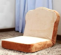 an upholstered chair sits on the carpet in front of a window