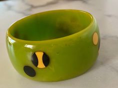 "Brandon Welch created this beautiful Dotted Bakelite bangle bracelet. It features 3 distinctly different types of Dots, Brandon used a lime green swirl bracelet and decorated it with \"Cookie\" dots, the black and cream, and black and cream dots on this bracelet in a an alternating UP DOWN pattern. 1.75 inches wide. Photos tell the story. This bracelet was made for me about 15 years ago so the vintage patina is returning to the piece. Signed with Brandon's signature \"B\" Just beautiful. What a Green Cuff Bracelet Gift, Handmade Green Round Cuff Bracelet, Adjustable Round Green Cuff Bracelet, Unique Green Bangle Bracelet, Unique Green Cuff Bracelet Bangle, Adjustable Green Round Bangle, Unique Green Cuff Bangle Bracelet, Unique Green Bangle Cuff Bracelet, Unique Green Round Bangle