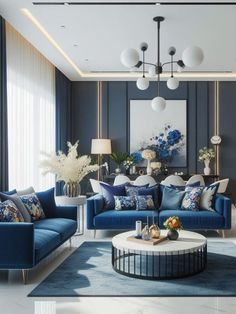 a living room with blue couches and white tables